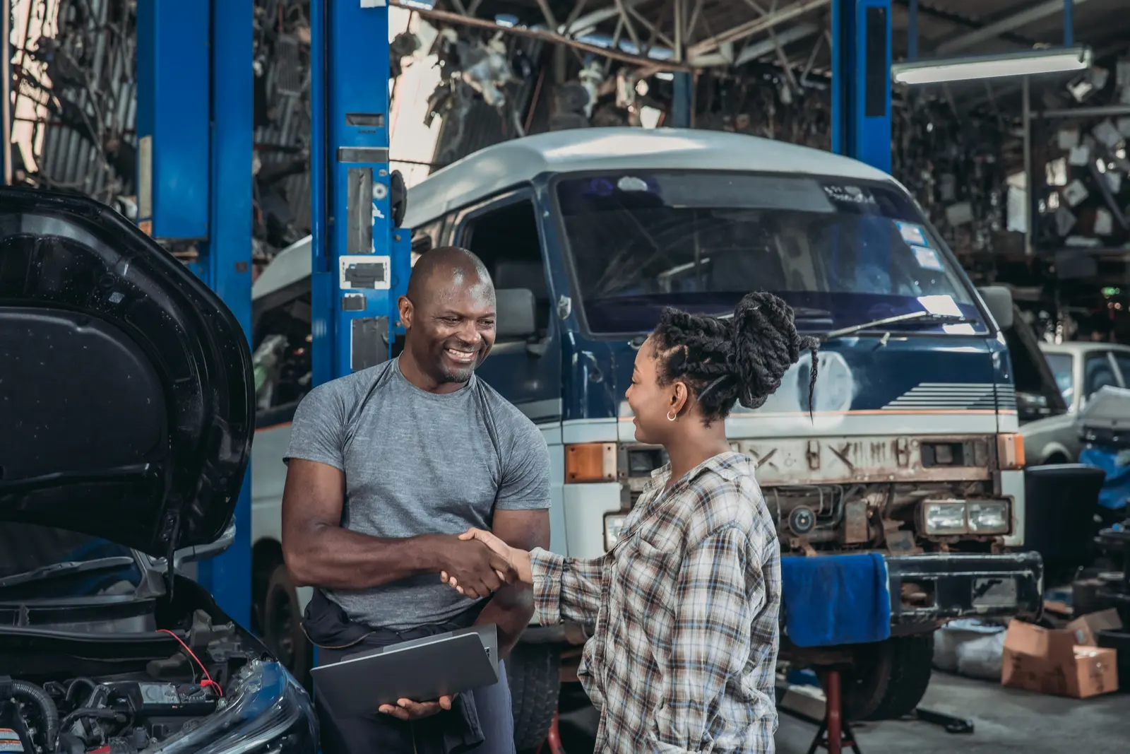 Mechanic greeting a customer in an auto repair shop