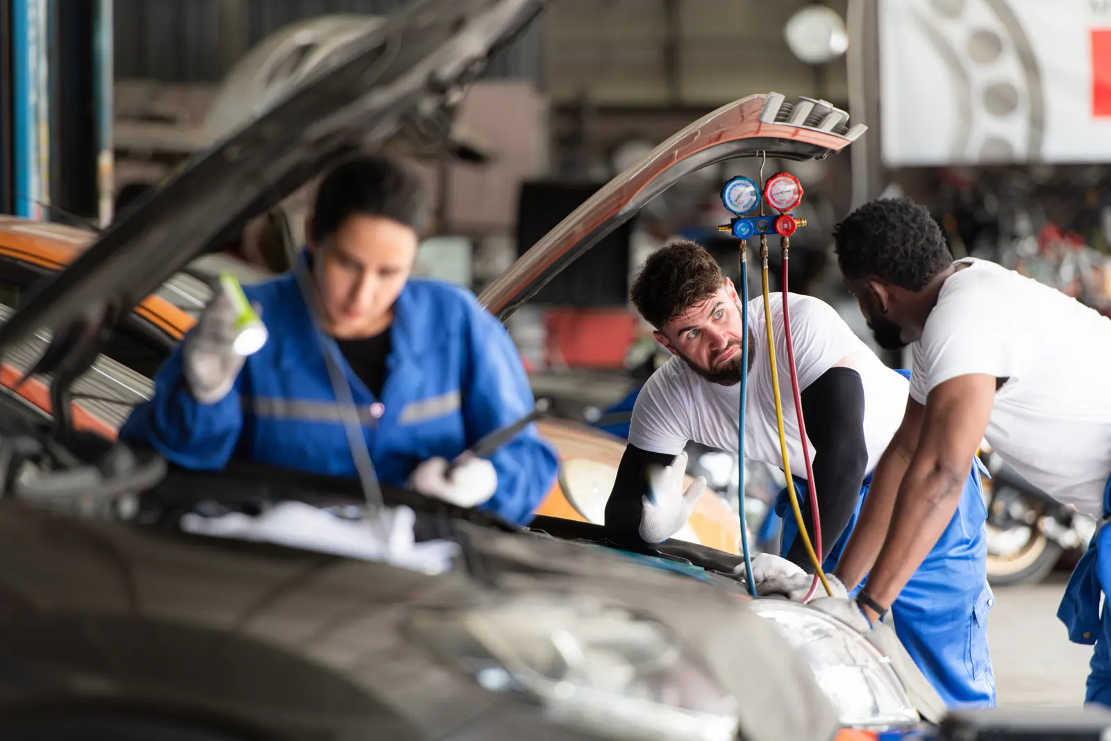 Technicians diagnosing a vehicle in an auto repair shop